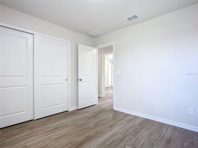 35 Wood Acre Ln, Palm Coast, FL 32164 - unfurnished bedroom with light hardwood / wood-style floors and a closet