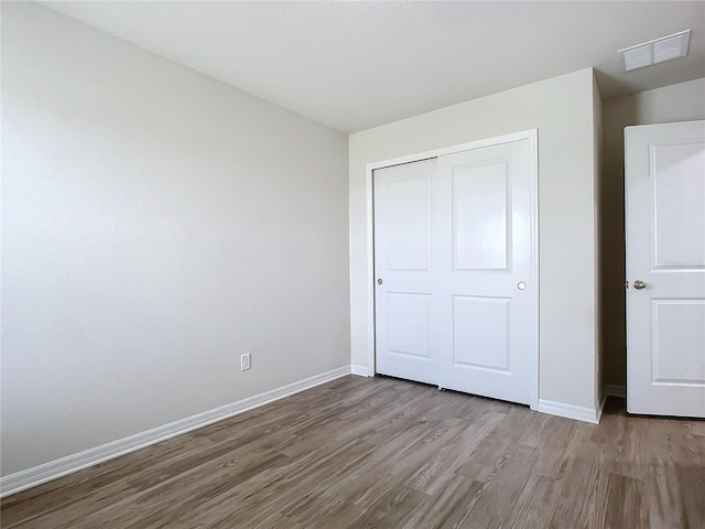 35 Wood Acre Ln, Palm Coast, FL 32164 - unfurnished bedroom with hardwood / wood-style flooring and a closet