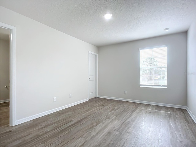 35 Wood Acre Ln, Palm Coast, FL 32164 - spare room with hardwood / wood-style floors and a textured ceiling