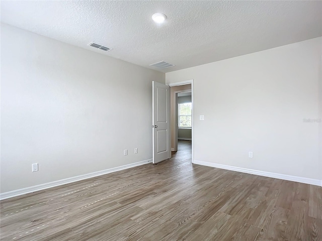 35 Wood Acre Ln, Palm Coast, FL 32164 - unfurnished room with wood-type flooring and a textured ceiling