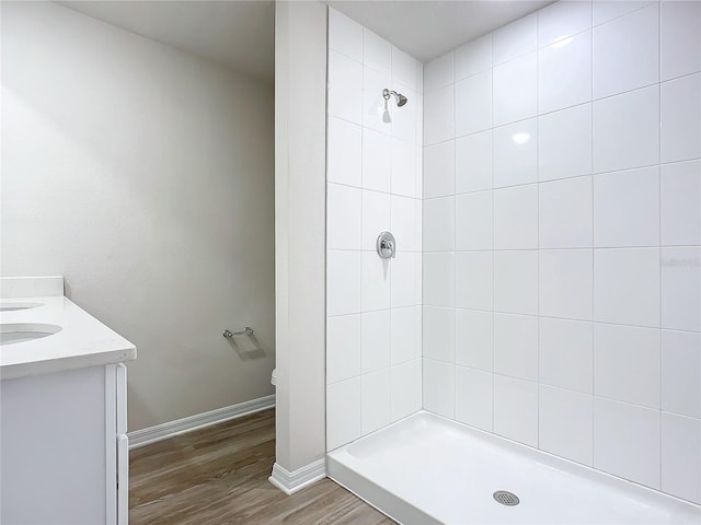 35 Wood Acre Ln, Palm Coast, FL 32164 - bathroom featuring hardwood / wood-style flooring, tiled shower, and vanity