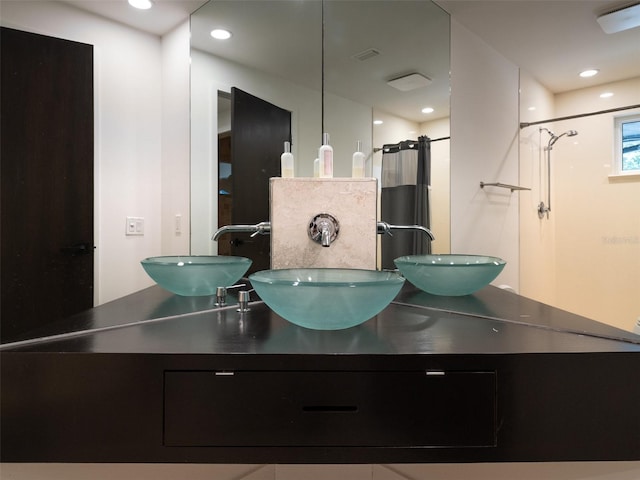 bathroom featuring vanity, curtained shower, and backsplash