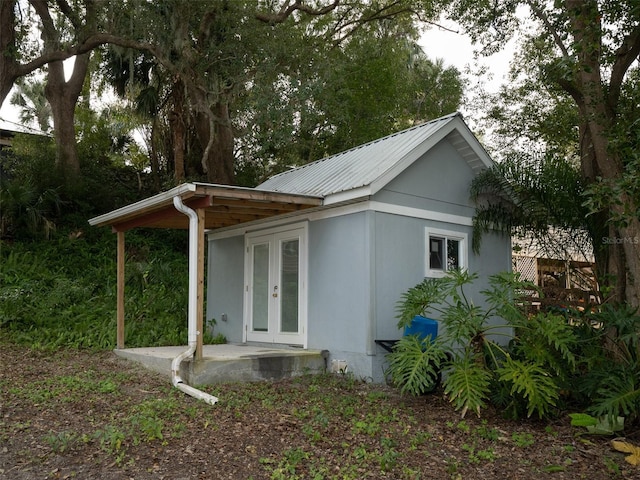 view of side of property with french doors