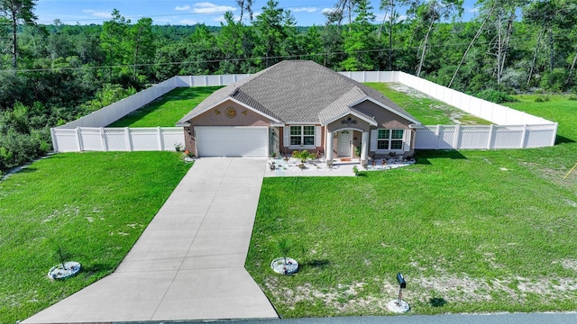 view of front of home featuring a garage and a front yard