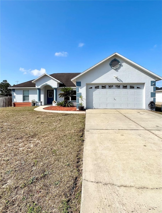 ranch-style home featuring a garage and a front yard