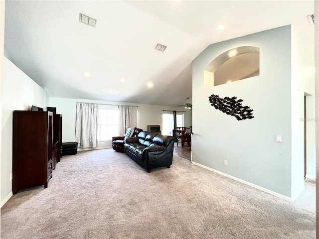 living room with lofted ceiling, light carpet, and ceiling fan