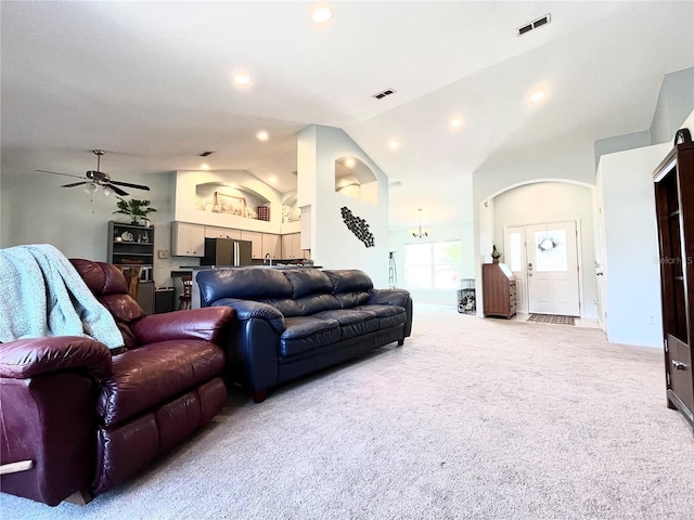 living room featuring ceiling fan, light colored carpet, and vaulted ceiling