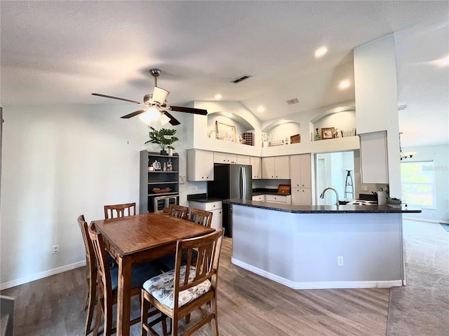 interior space with dark hardwood / wood-style flooring, vaulted ceiling, and ceiling fan