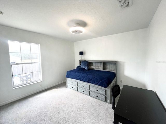 bedroom with carpet and a textured ceiling