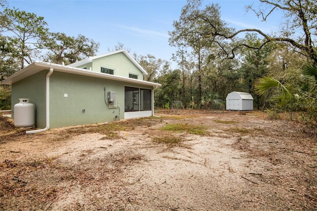 view of home's exterior featuring a shed and a sunroom