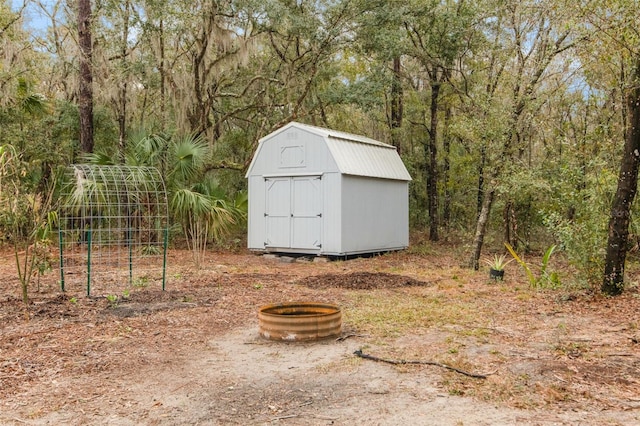 view of outbuilding with an outdoor fire pit