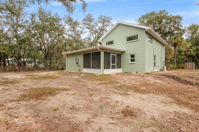 rear view of house with a sunroom and central air condition unit