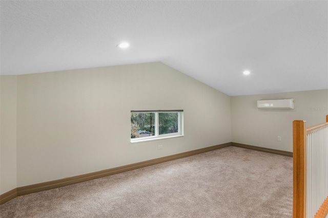 additional living space with lofted ceiling, light carpet, and a wall mounted AC