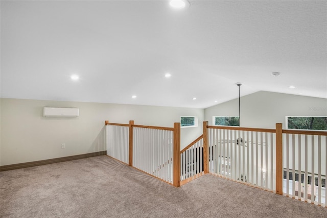 interior space featuring vaulted ceiling, a wall unit AC, and carpet