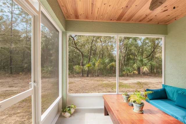 unfurnished sunroom featuring wood ceiling and a wealth of natural light