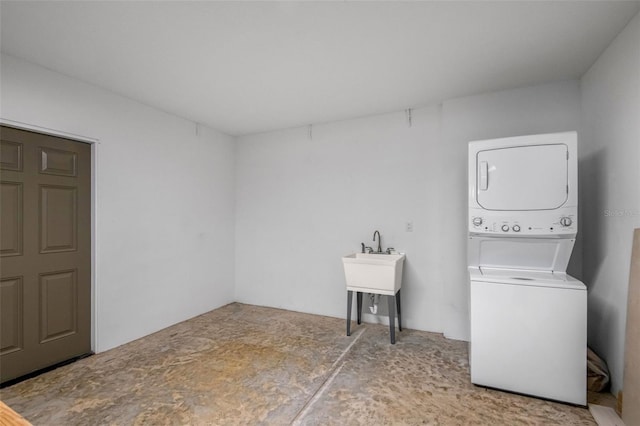 clothes washing area featuring stacked washer and dryer