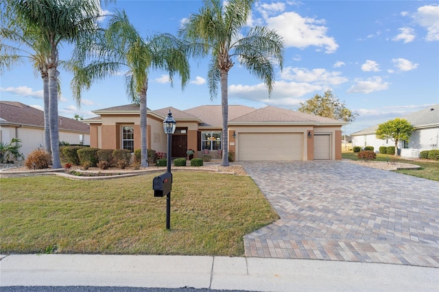 ranch-style house with a garage and a front lawn