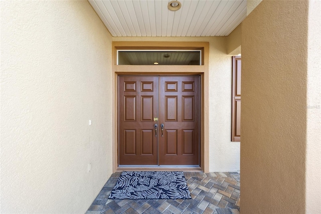 doorway to property with stucco siding