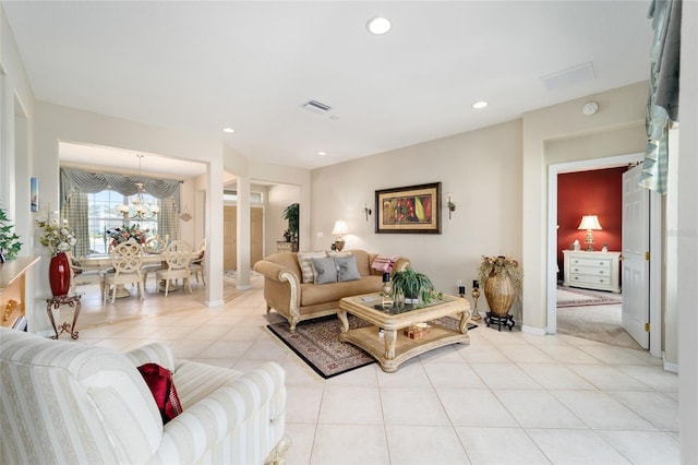 living area with visible vents, an inviting chandelier, light tile patterned flooring, ornate columns, and recessed lighting