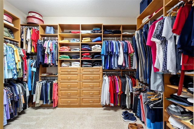 walk in closet with carpet