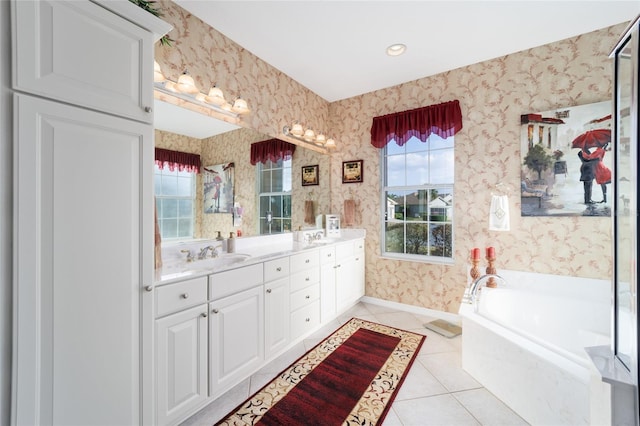 full bath featuring double vanity, wallpapered walls, a sink, baseboards, and tile patterned floors