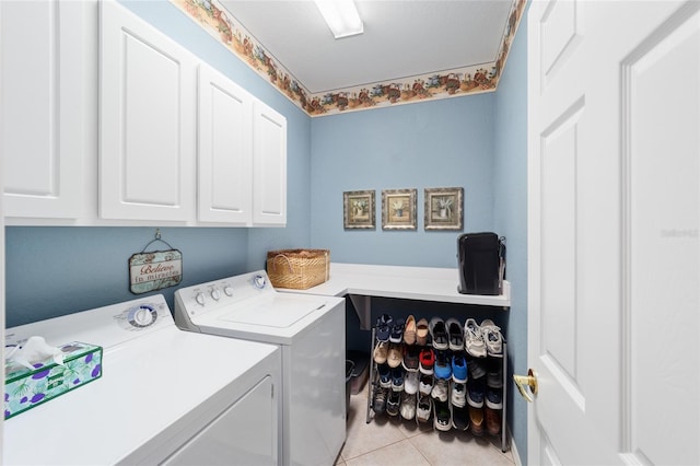 laundry room featuring cabinet space, washer and clothes dryer, and light tile patterned flooring