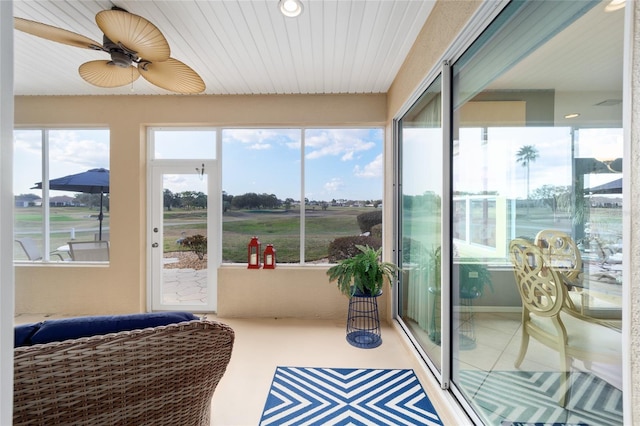 sunroom with a healthy amount of sunlight and ceiling fan