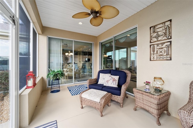 sunroom featuring a ceiling fan