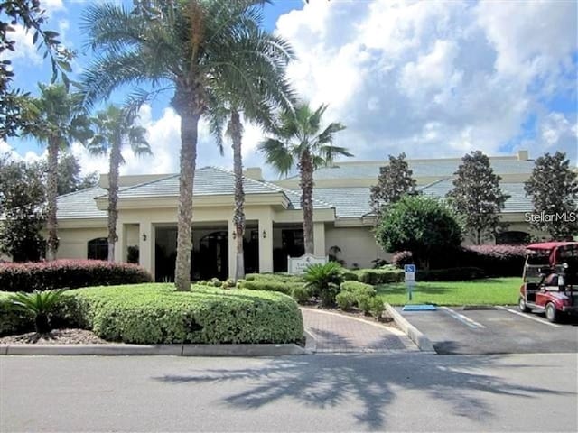 view of front of property featuring uncovered parking and stucco siding