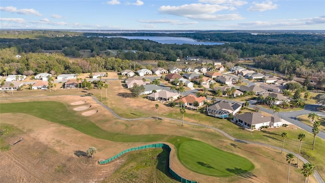 aerial view with a water view, view of golf course, and a residential view