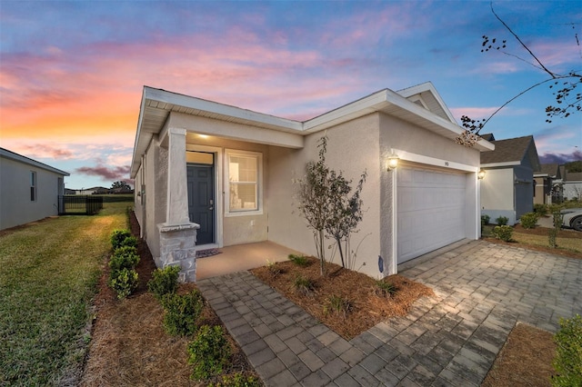 view of front of house featuring a garage and a lawn