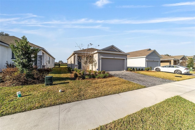 ranch-style house featuring a garage and a front lawn