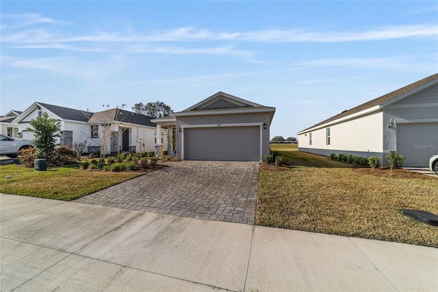 ranch-style home with a garage and a front lawn