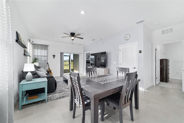 tiled dining space with ceiling fan