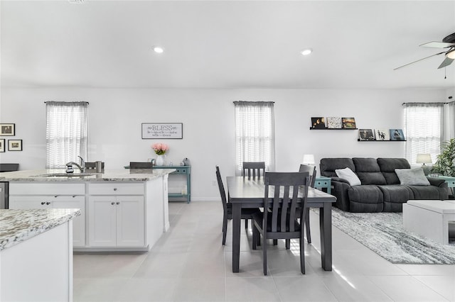 dining area featuring ceiling fan, plenty of natural light, and sink