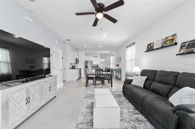 tiled living room with ceiling fan