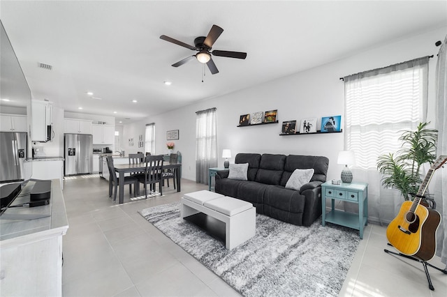 living room featuring ceiling fan and light tile patterned flooring