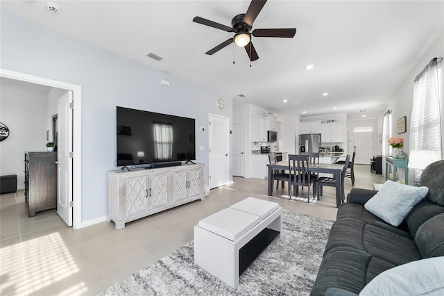 living room with light tile patterned flooring and ceiling fan