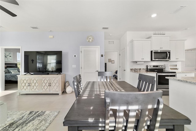 dining area with ceiling fan and light tile patterned floors