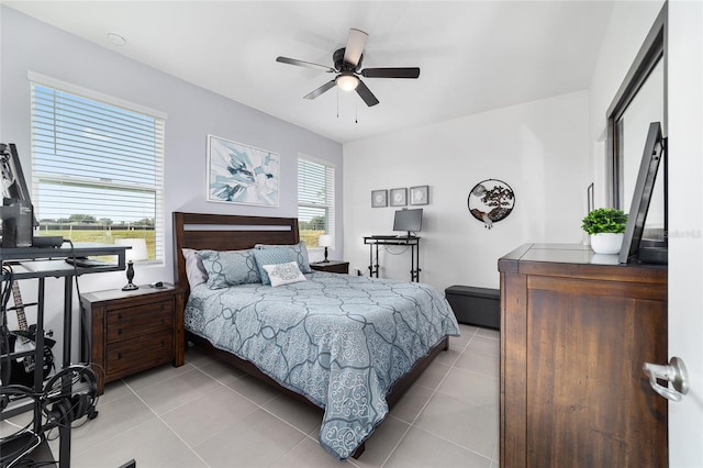 bedroom with ceiling fan, multiple windows, and light tile patterned floors