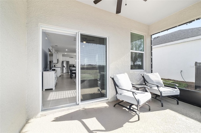 exterior space with a balcony and ceiling fan