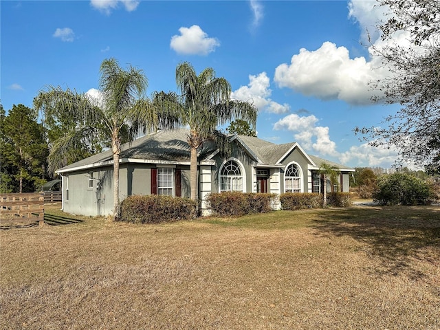 ranch-style house with a front lawn