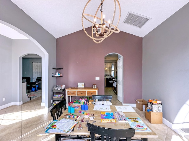 dining room with an inviting chandelier, vaulted ceiling, and light tile patterned floors