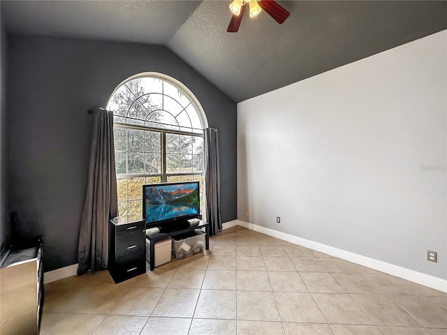 tiled living room featuring vaulted ceiling, a textured ceiling, and ceiling fan