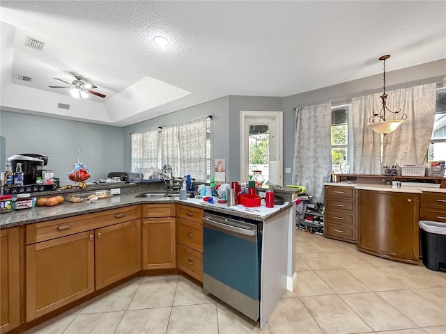 kitchen with sink, decorative light fixtures, light tile patterned floors, dishwasher, and a raised ceiling