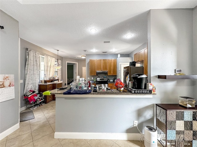 kitchen featuring light tile patterned floors, hanging light fixtures, stainless steel appliances, a textured ceiling, and kitchen peninsula