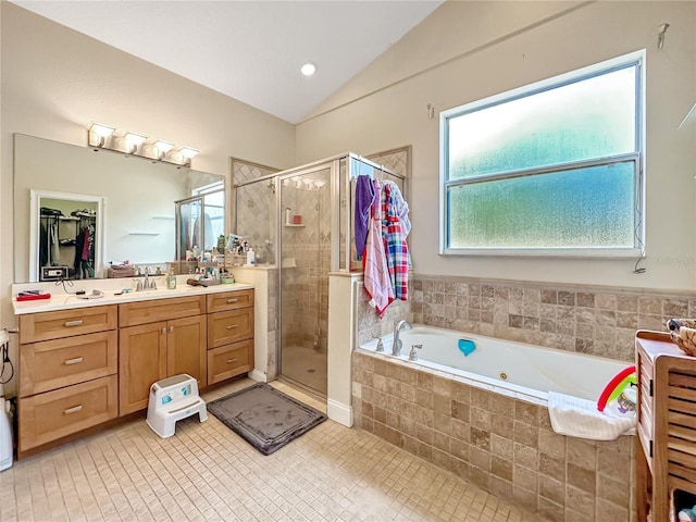 bathroom with plus walk in shower, lofted ceiling, tile patterned floors, and vanity