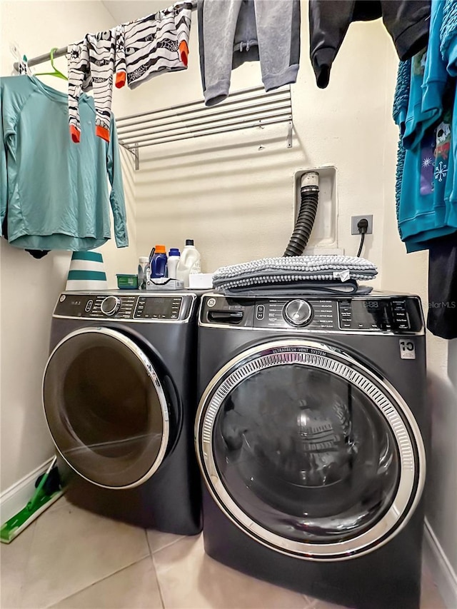 washroom featuring washing machine and clothes dryer and tile patterned floors