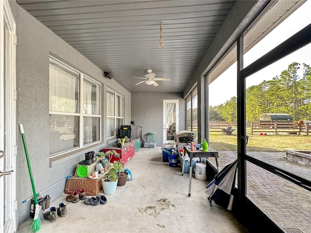 sunroom / solarium featuring ceiling fan