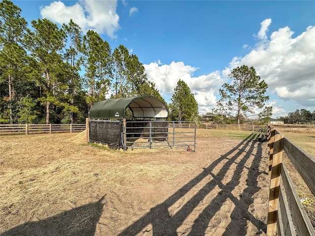 view of yard with an outbuilding and a rural view